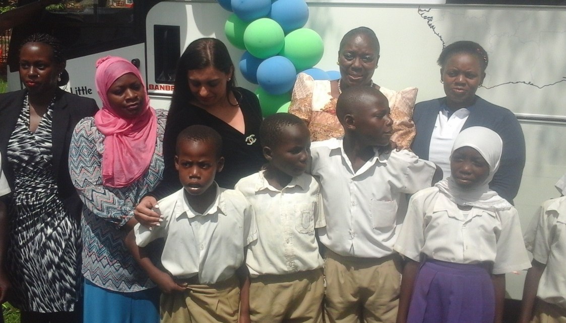 Speaker Kadaga poses in a group photo with pupils and top executives of Finance trust Bank and Craft Silicon Foundation