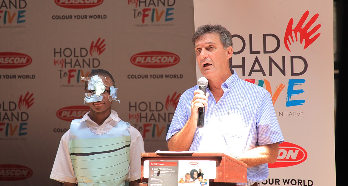 Mr Chris Nugent, the Kansai Plascon Managing Director speaks during the launch of the Hold my Hand to 5 campaign, healso handed over the newly refurbished class room blocks to Nakasero Primary School