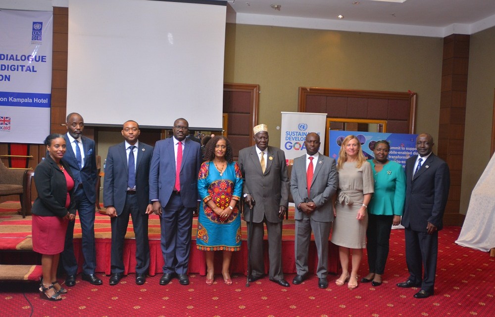 Gen. Moses Ali (5th R), First Deputy Prime Minister of the Republic of Uganda, Charles Rasugu (4th R), Director Sub-Saharan Africa, GSMA, Eng. Charles Lwanga (R), Assistant Commissioner, Telecommunications & Post Ministry of ICT, and Yemesrach Assefa Workie (L), Economics Advisor, UNDP, and other officials pose for a photo during the Uganda National Dialogue for Digital Transformation Conference at Sheraton Hotel, Kampala. The purpose of the conference was to discuss how Uganda could advance the national and global SDGs agenda through mobile-enabled digital transformation.