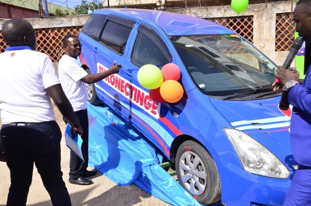 Paddy Muramiirah (R), CEO Crown Beverages (Pepsi) after test-running one of the cars while Mr. Isaac Sekasi (L) and other Crown Beverages looks on during the media launch of the Tukonectinge with Pepsi Campaign that took place today, 11th April 2018 at the company's Headquarters in Nakawa industrial area.