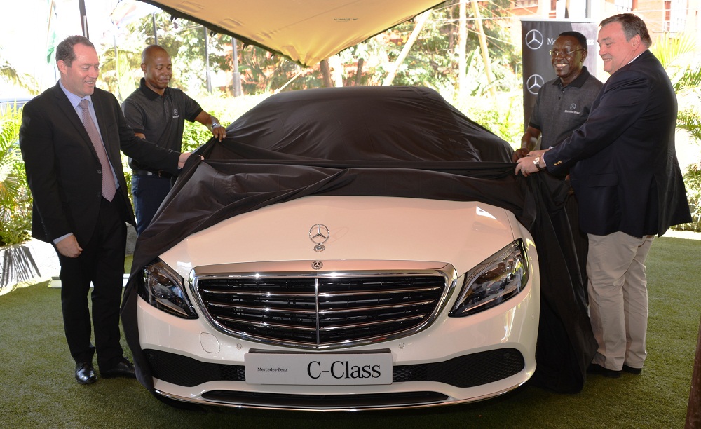 Ian Middleton (left), the Managing Director of DT Dobie Edward Githinji (Second left), Sales Executive, Gerald Trempont (right), CFAO Brand Manager and Lawrence Kiambati (second right), Senior Sales Executive unveil the new Mercedes Benz C Class luxury saloon for the Kenya market.
