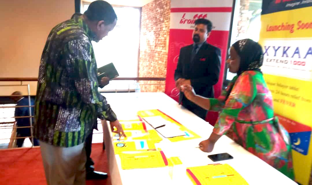 Commissioner Patrick Tusiime being briefed by one of Troikaa representative on the various products they offer on the Ugandan markets