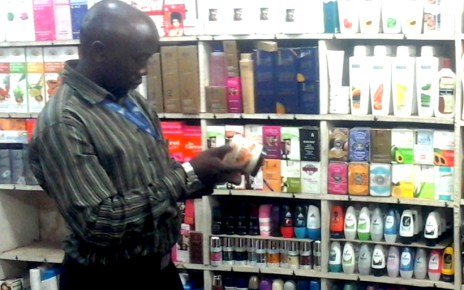 Uganda National Bureau of Standards official checks suspected substandard cosmetics in a shop in Kampala