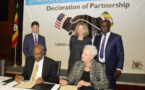 Uganda’s Prime Minister Dr Ruhakana Rugunda and US Ambassador to Uganda Deborah R. Malac signing the partnership