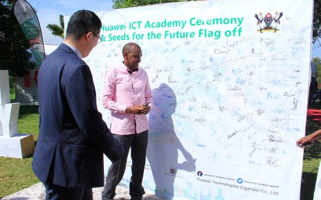 The ICT Minister Hon Frank Tumwebaze making an autograph at the ICT Academy Ceremony