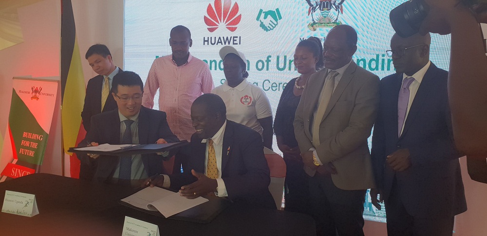 Uganda's Minister for ICT and National Guidance Frank Tumwebaze (In Pink Shirt) witnessing the signing of a Memorandum of Understanding between Huawei Uganda and Makerere University to establish the first ICT Academy.