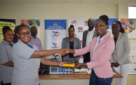 UNBS acting Executive Director Patricia Ejalu (Left) receiving the gadgets from DFID Programme Manager Lydia Nandawula during the event