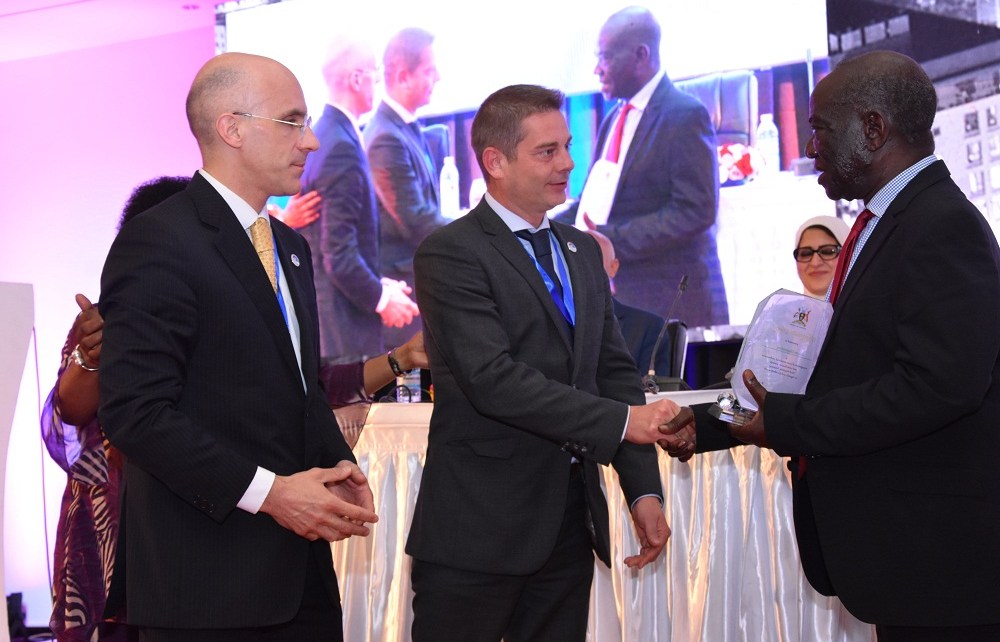 The Vice President of Uganda, Edward Kiwanuka Ssekandi (Right) hands over an award of exceptional performance and contribution towards viral Hepatitis response in Uganda and the world, to Nicolas Granier, General Manager Africa (Centre) Infectious Disease - Markets, Rapid Diagnostics, Abbott and Jerome Clavel (Left), VP Global Marketing, Infectious Disease - Emerging Markets, Rapid Diagnostics, Abbott, during the opening ceremony of the Africa Hepatitis Summit at Speke Resort Munyonyo. Abbott is a manufacturer of medical diagnostics devices and kits.
