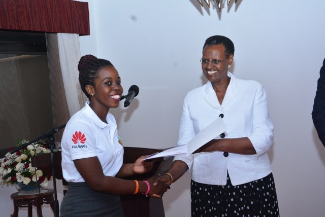 The First Lady and Minister of Education and Sports Janet Museveni handing over a certificate to one of the Seeds for the Future Competition winners.